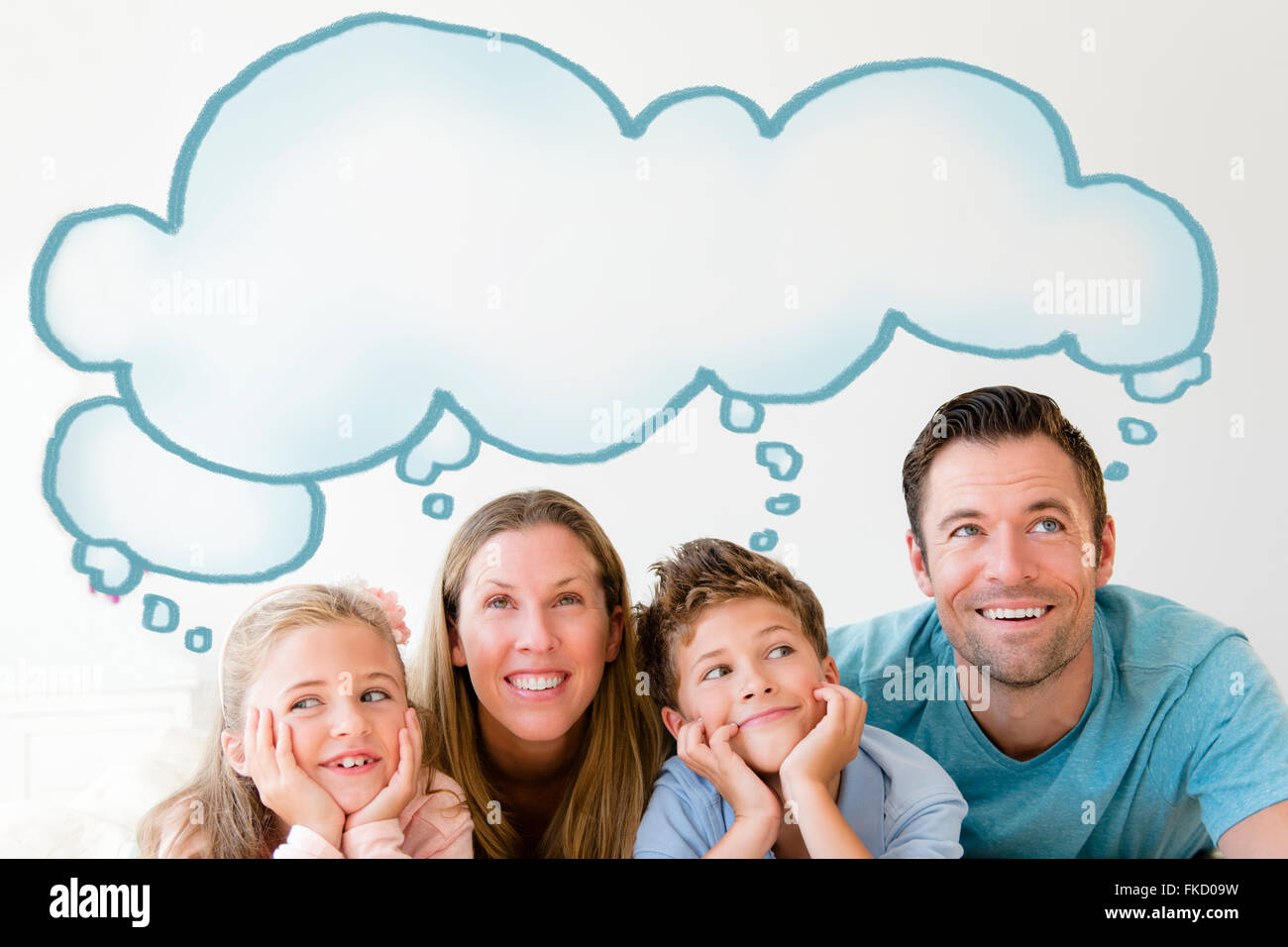 Family with two children (6-7, 8-9) day dreaming Stock Photo