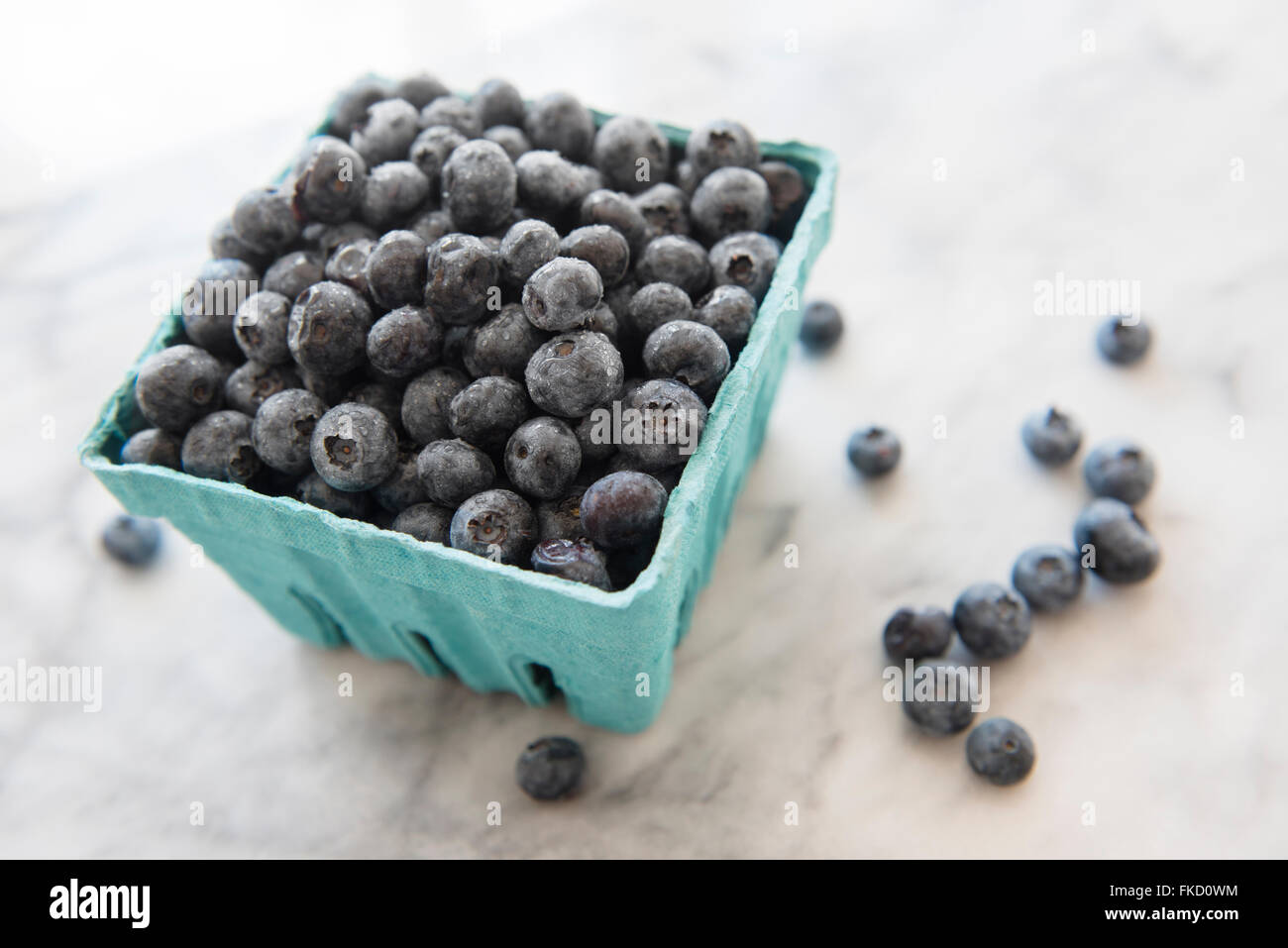 Heap of blueberries in container Stock Photo Alamy
