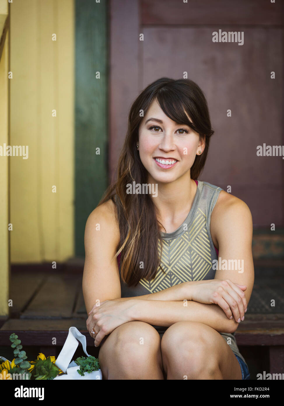 Portrait of young woman on porch Stock Photo - Alamy
