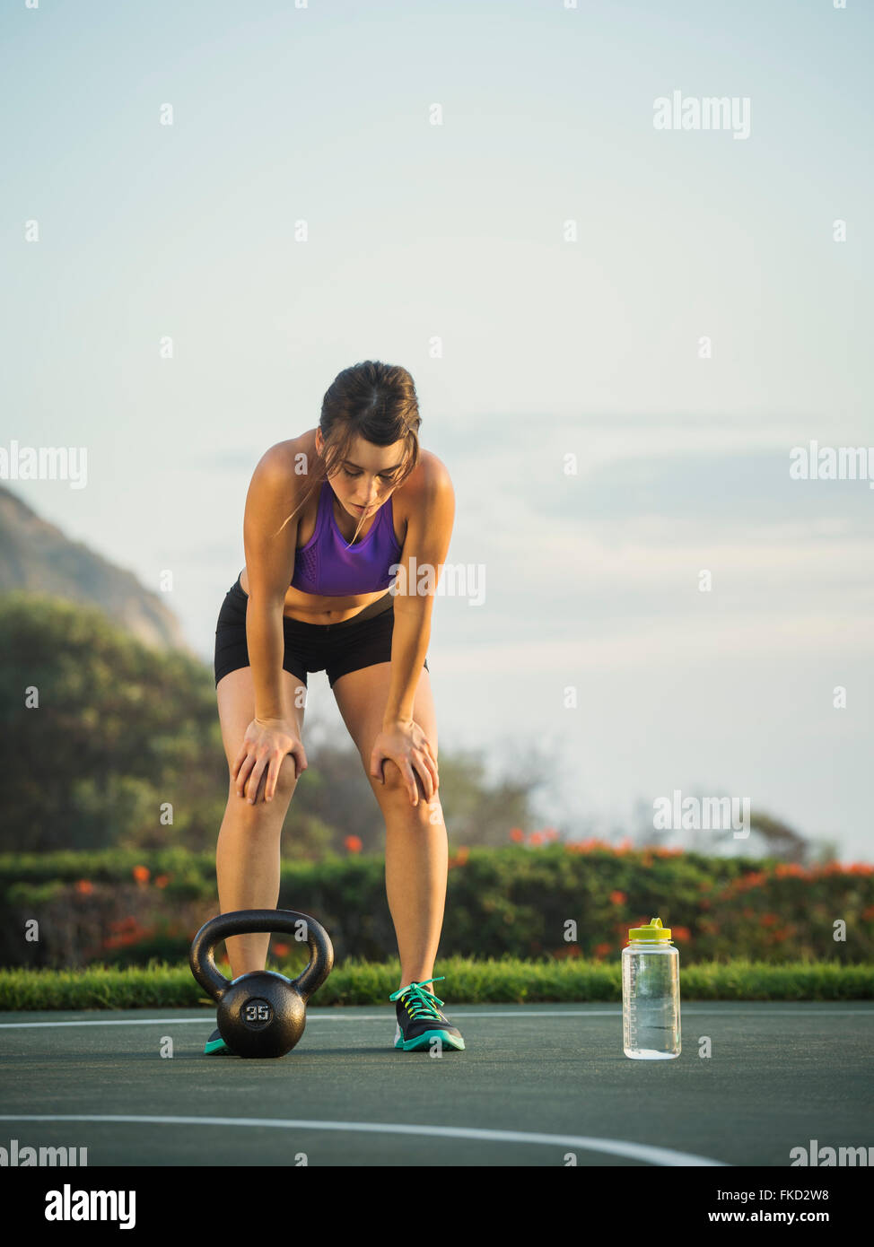 Young woman bending over resting Stock Photo