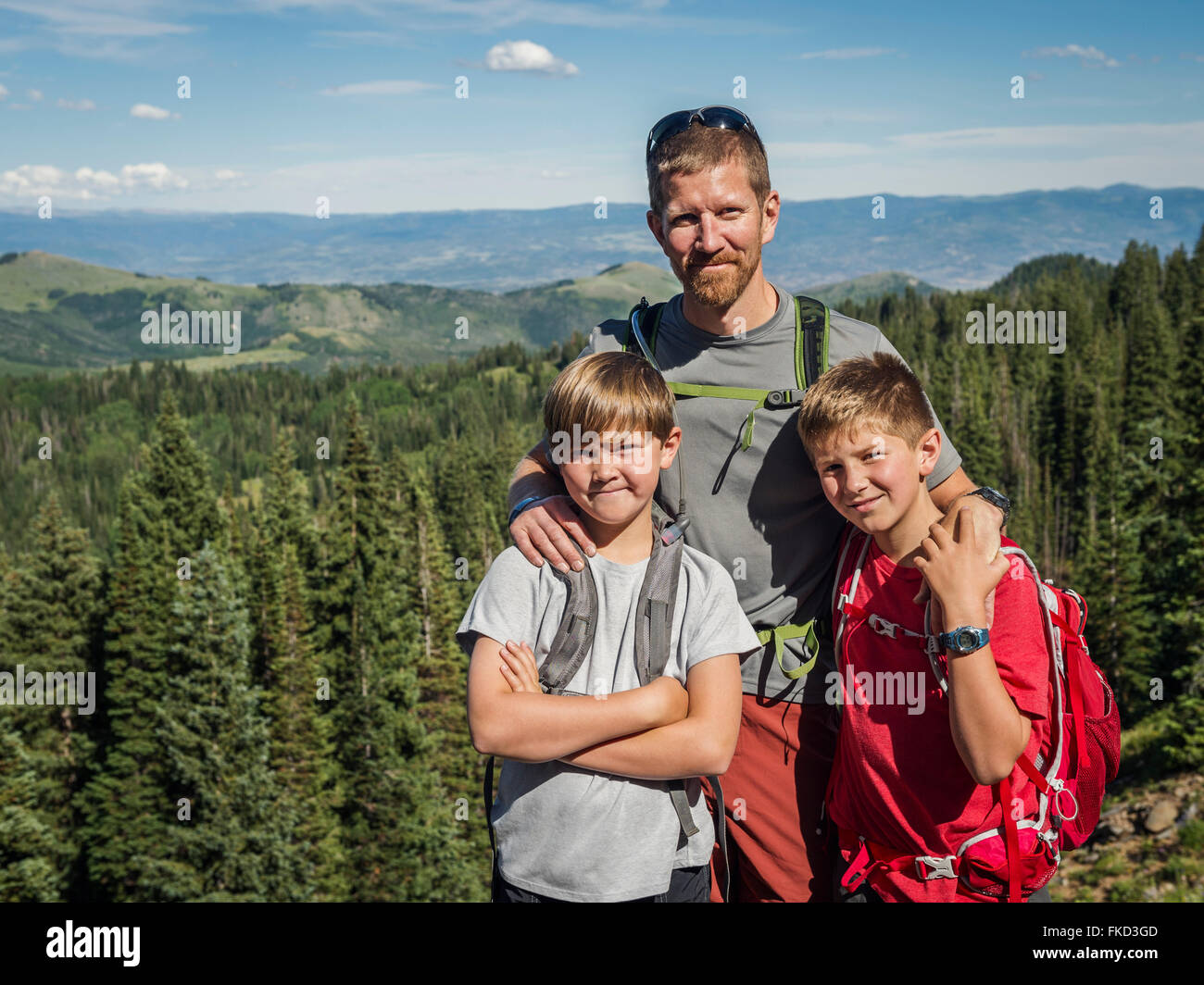 Father and sons (10-11, 12-13) outdoors Stock Photo
