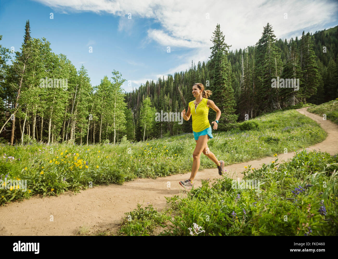 Mature woman running outdoors Stock Photo