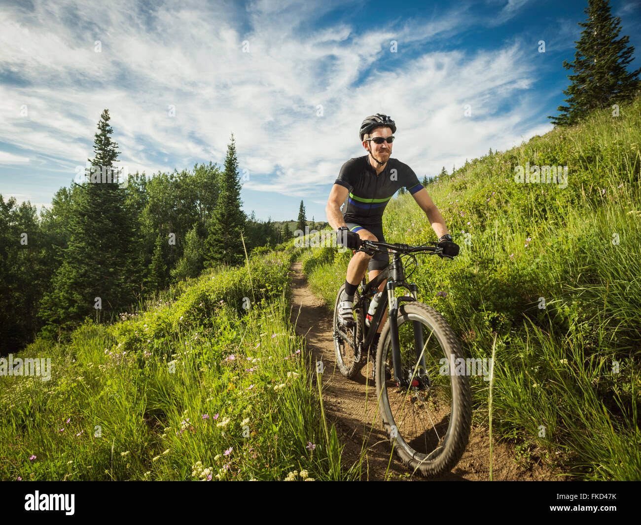 Mature man cycling outdoors Stock Photo