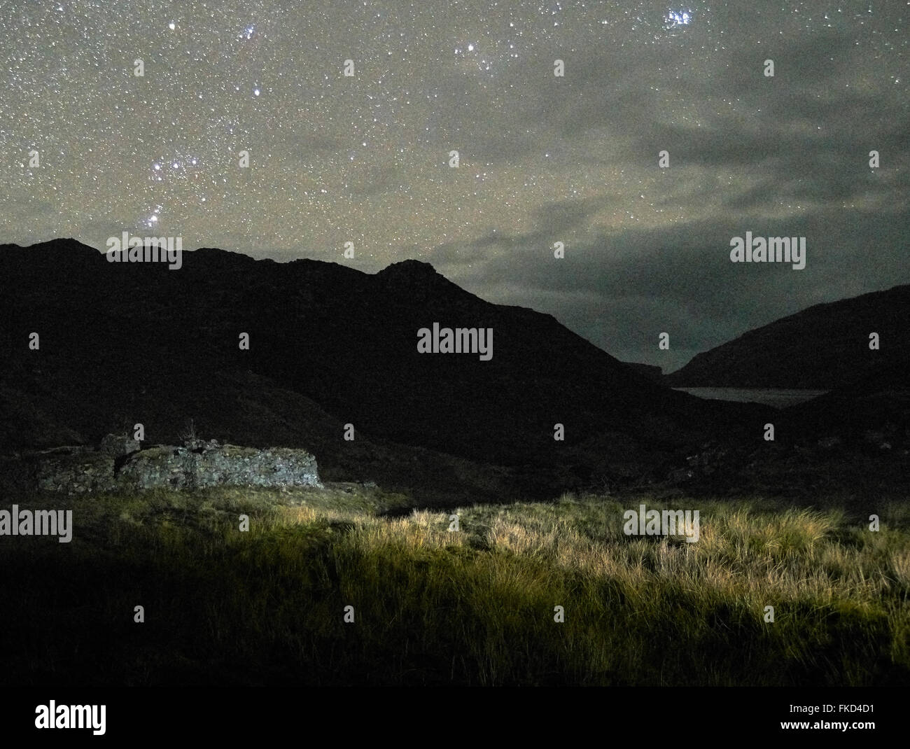 Long exposure at night of abandoned blackhouse on The Isle of Lewis with a very starry sky. Stock Photo