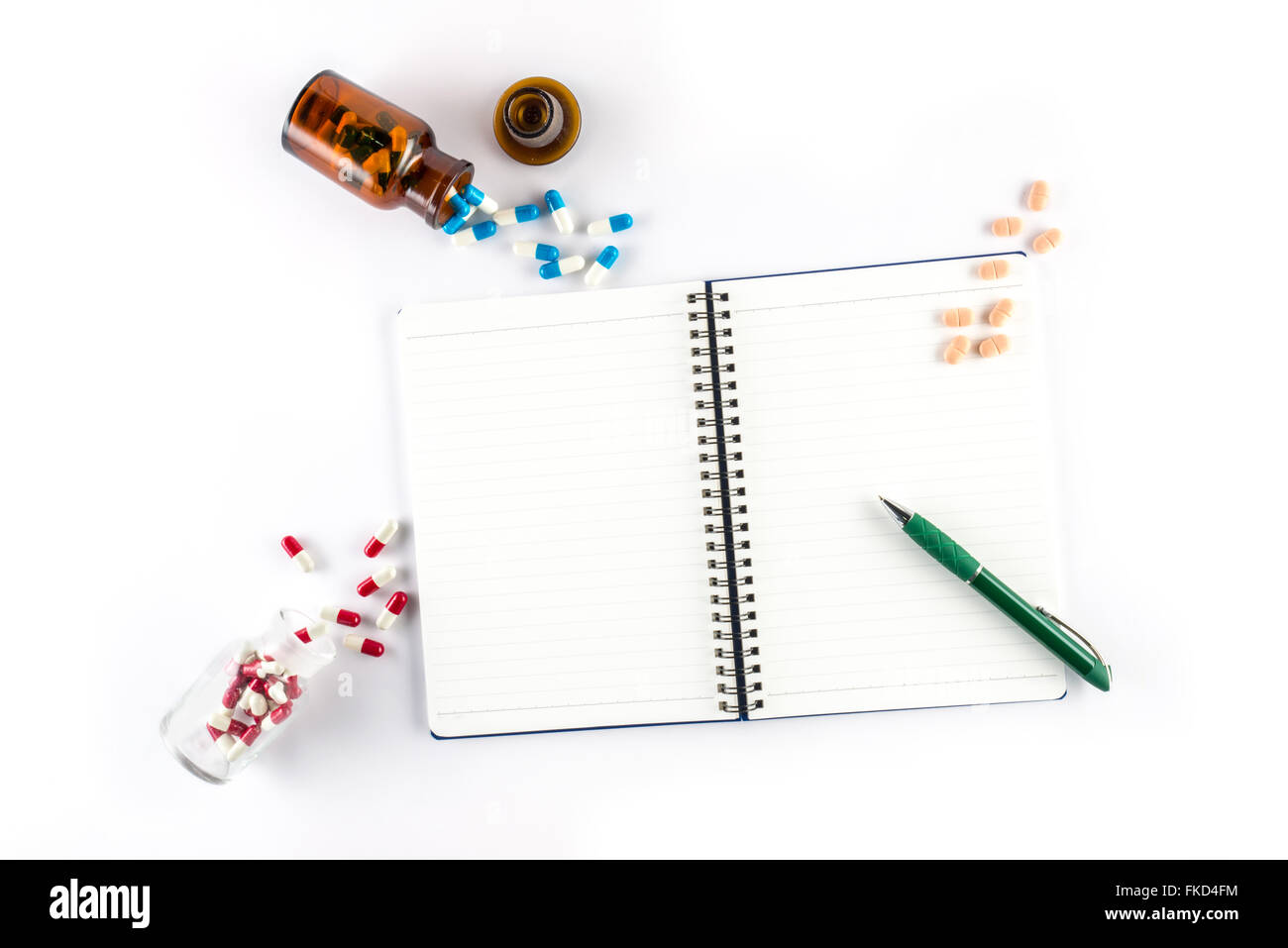 capsules and bottle with notebook and pen, prescription healthcare and medicine Stock Photo