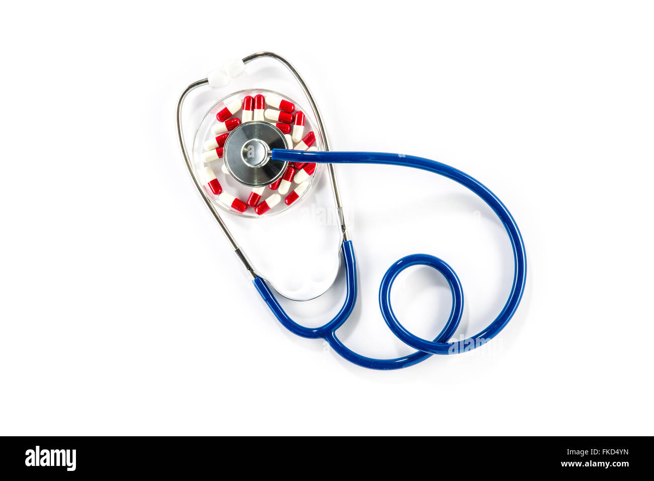 red capsule in Petri Dish with stethoscope, cardiology cardiovascular Stock Photo