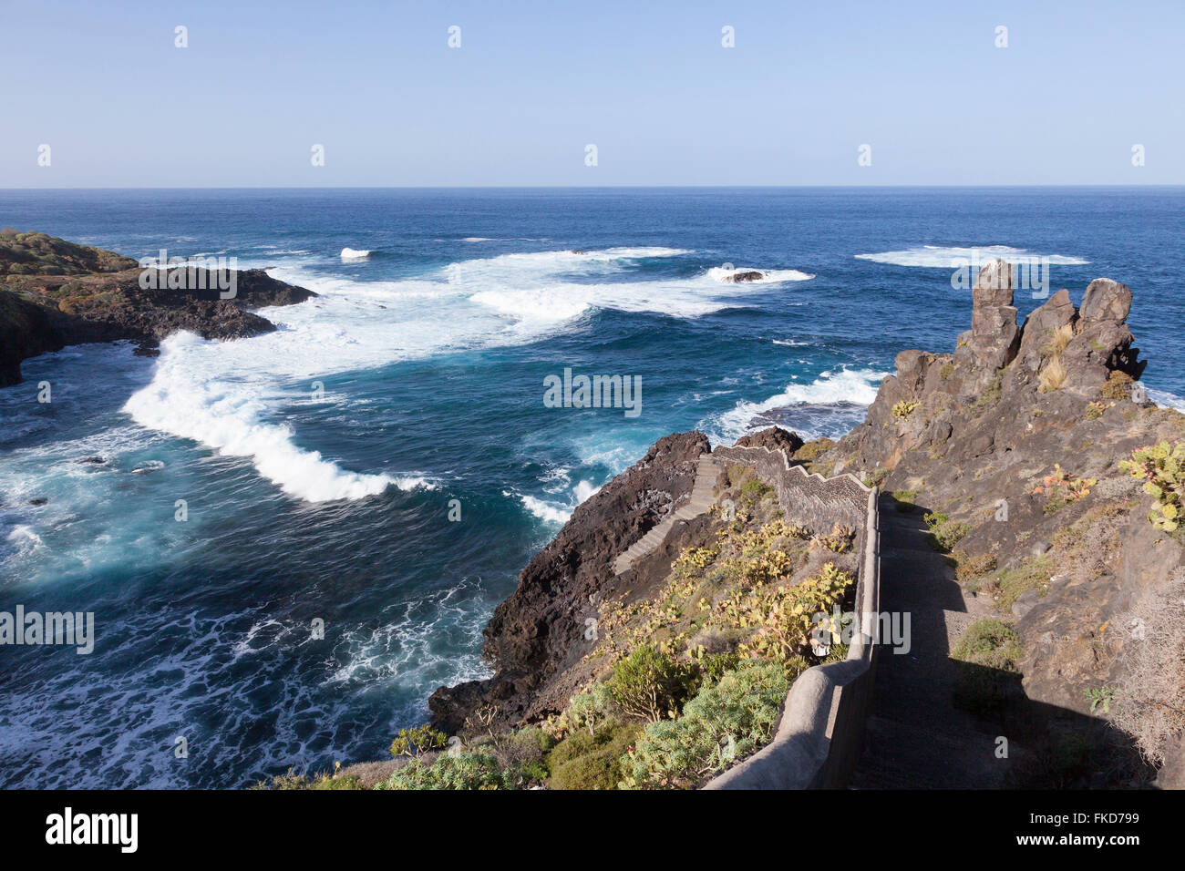 stairs on empty rocky north coast of Tenerife near the town of garachico with view over atlantic ocean and blue sky Stock Photo