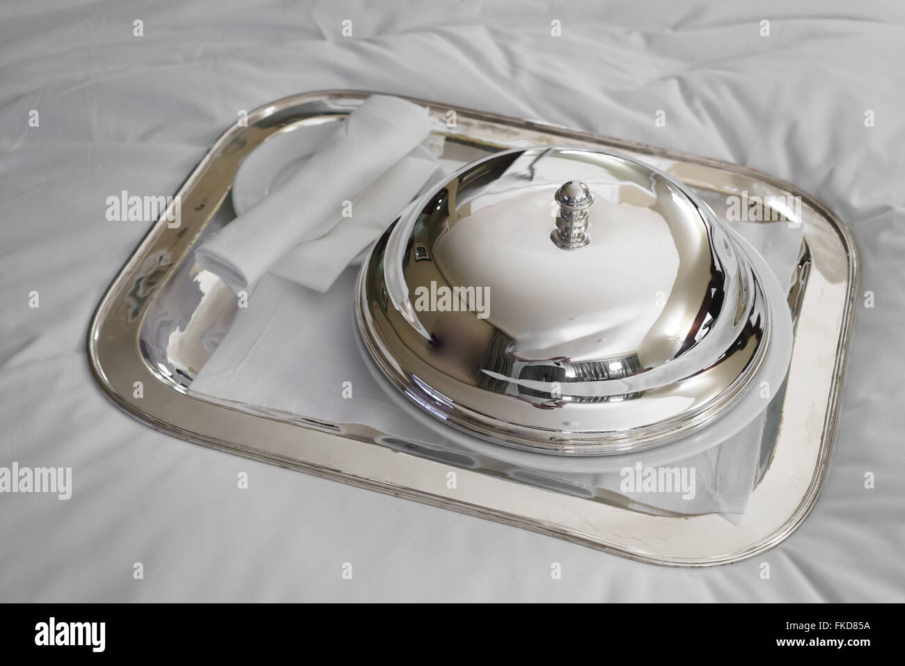 Domed silver lid on plate Stock Photo