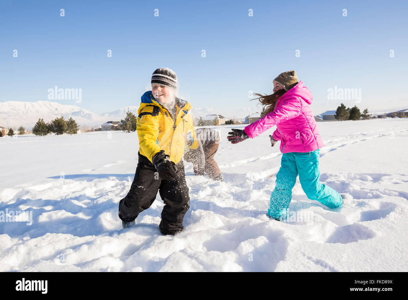 Children (8-9, 10-11) playing in snow Stock Photo