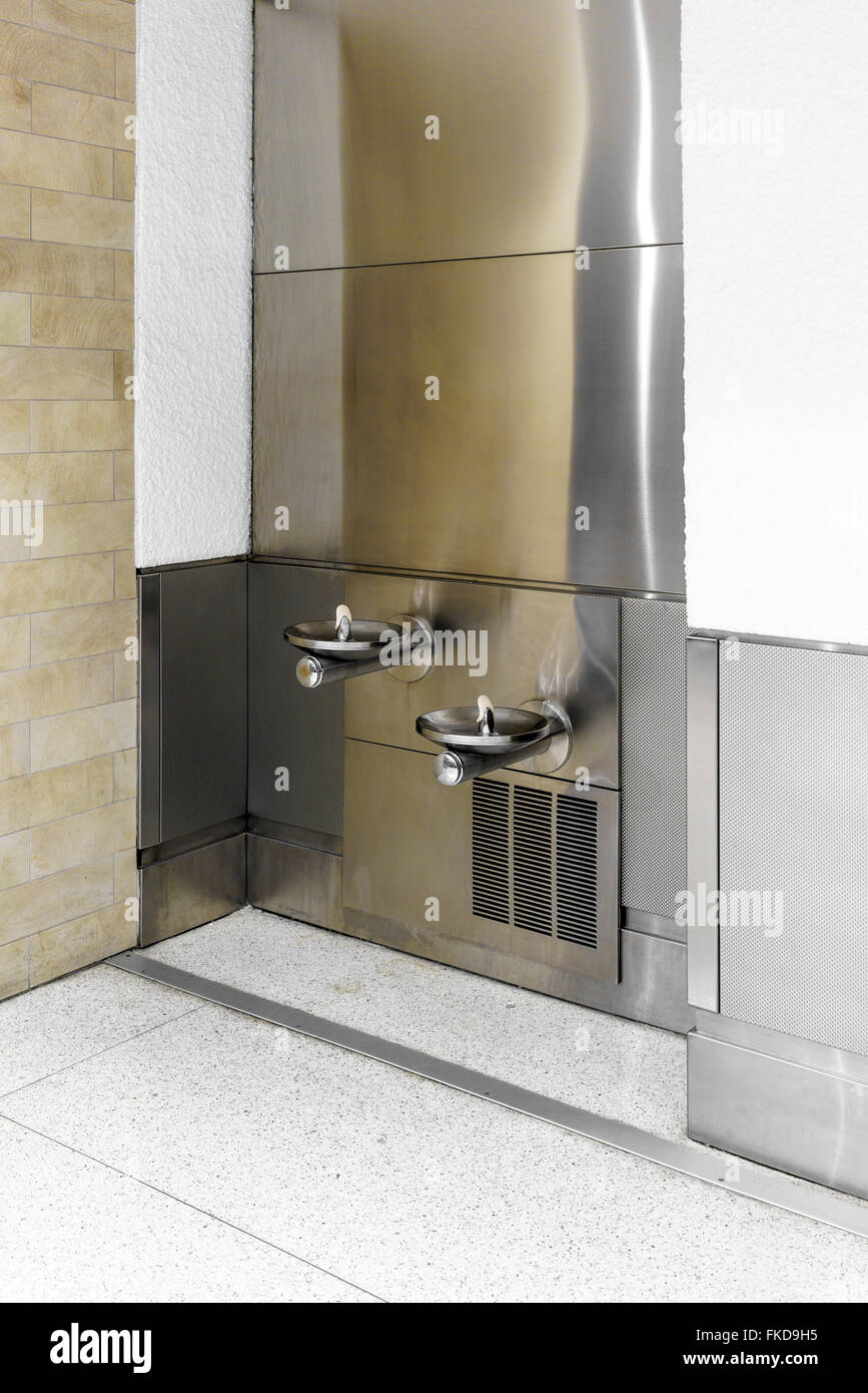 Two heights of drinking fountains at airport Stock Photo