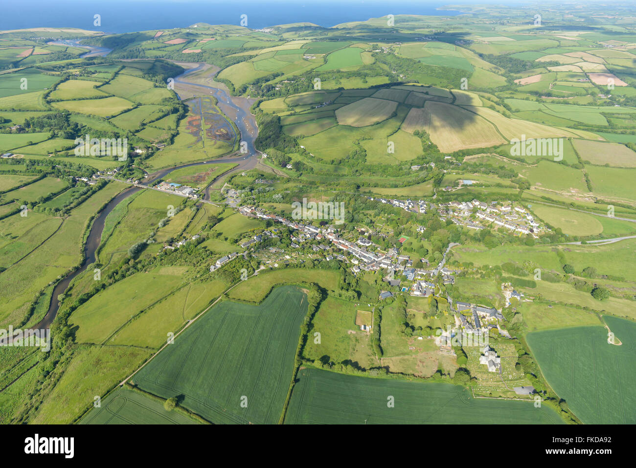 An aerial view of the village of Aveton Gifford, surrounding Devon countryside and coast Stock Photo
