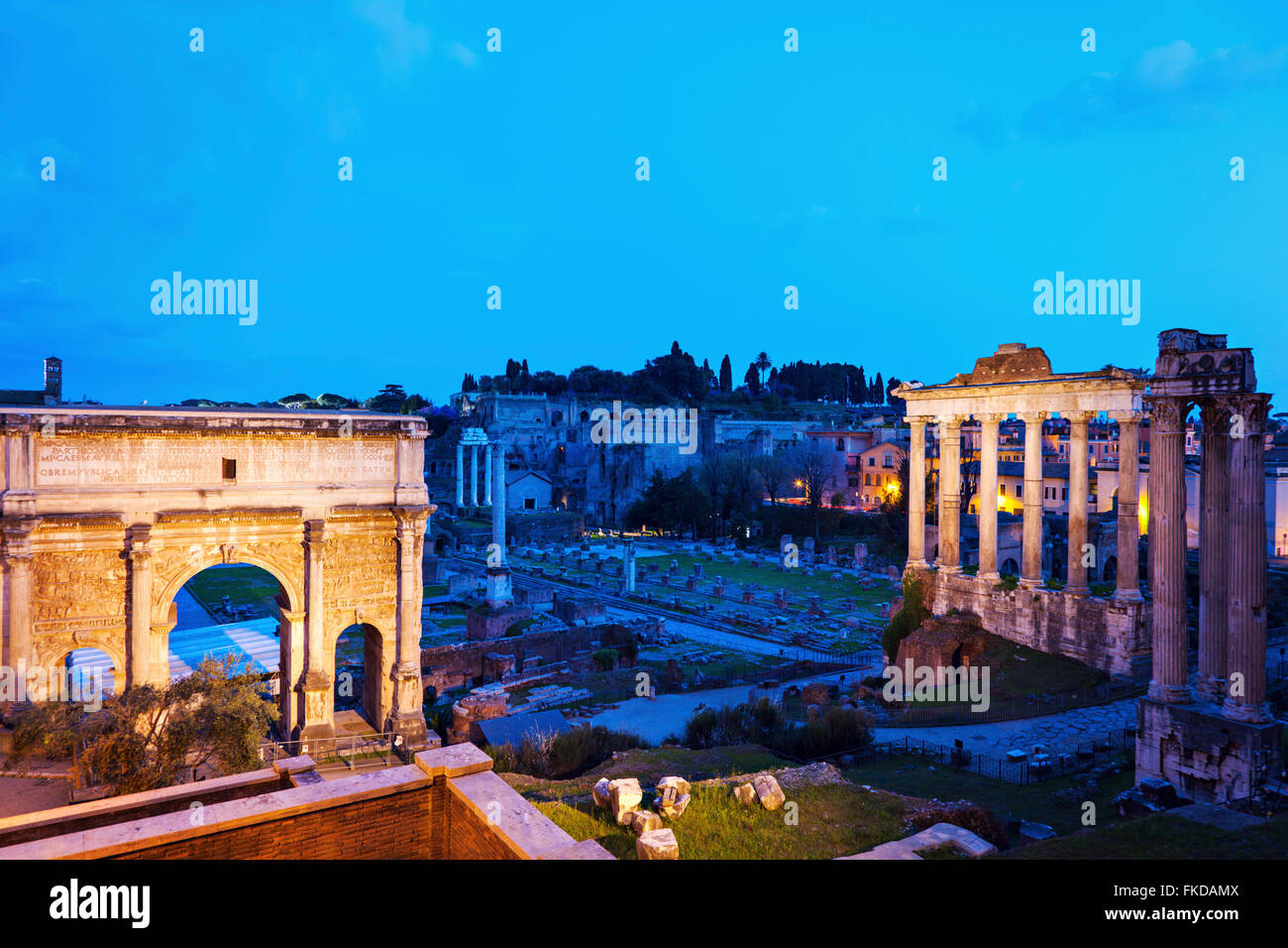 Arch of Septimius Severus and Roman Forum at dusk Stock Photo