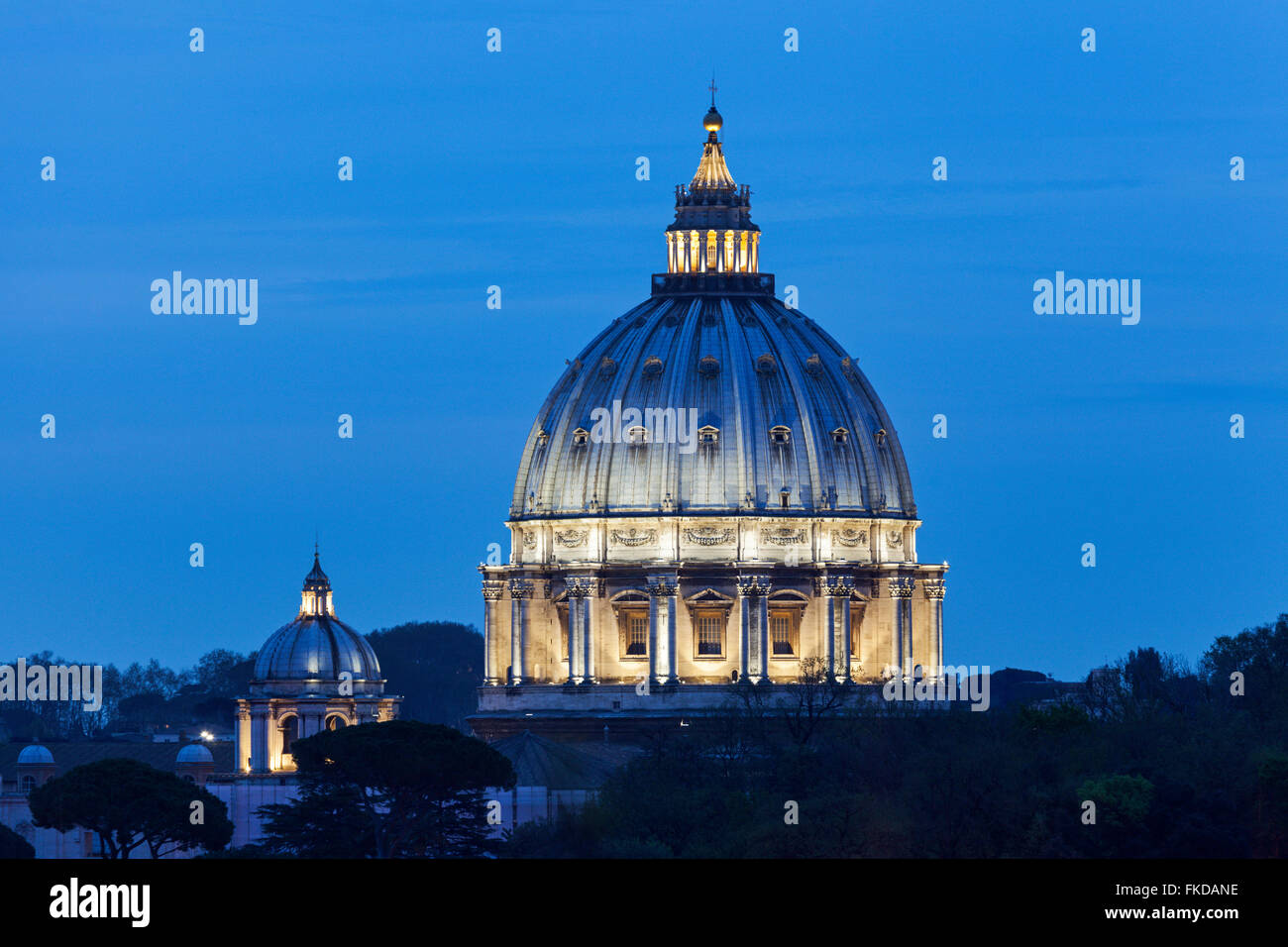Illuminated St. Peter's Basilica at dusk Stock Photo
