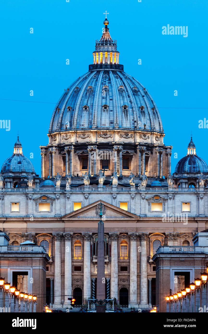 Illuminated St. Peter's Basilica at dusk Stock Photo