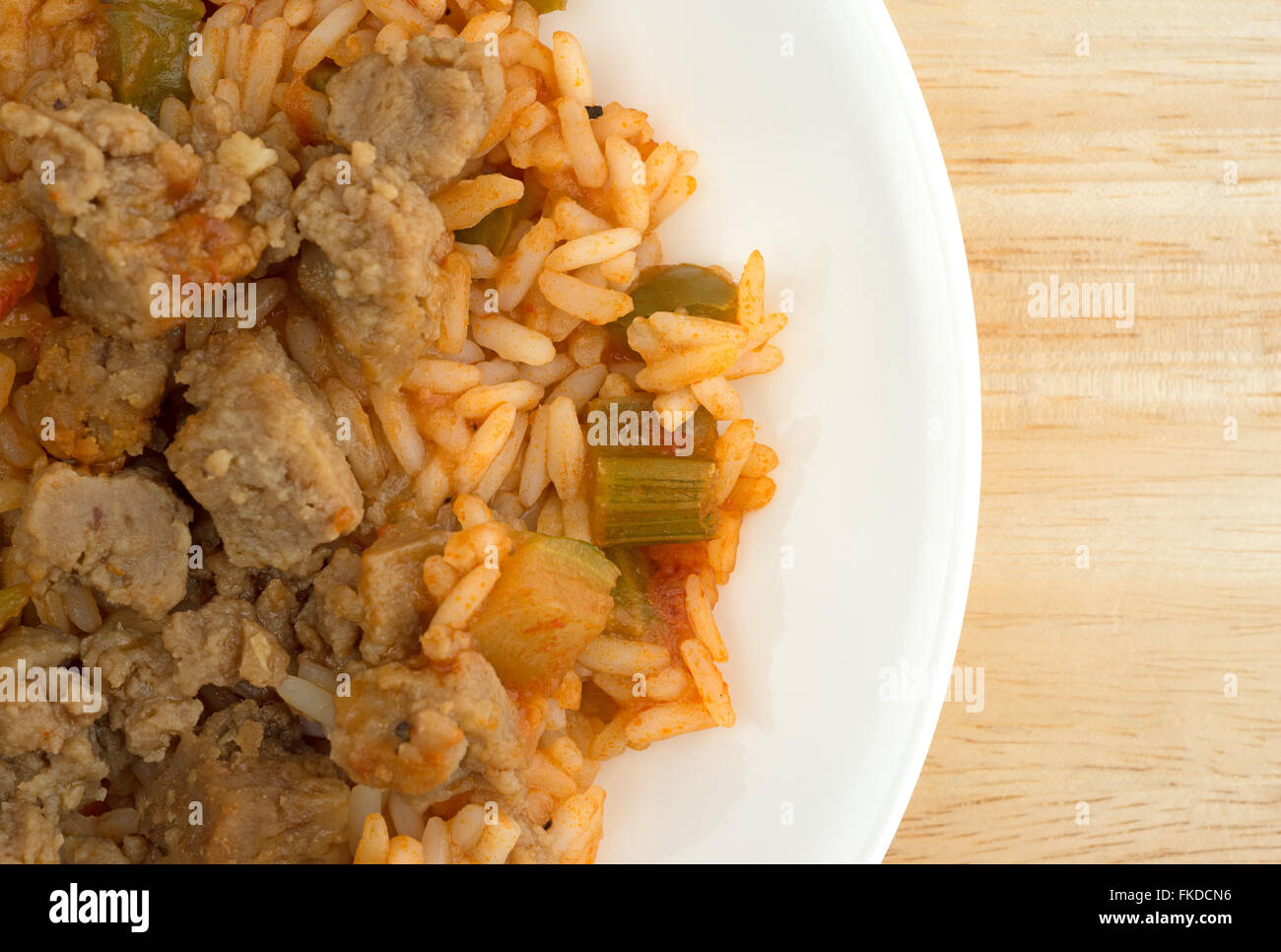 Top close view of a serving of rice, green peppers and chunks of beef ...