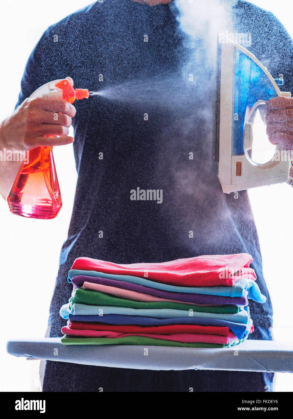 Man holding spray bottle cleaning hires stock photography and images