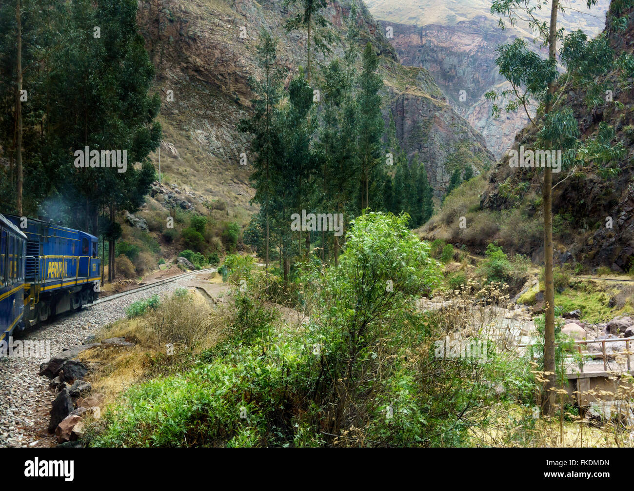 Train moving on railway track with mountain in background, Cusco, Peru Stock Photo
