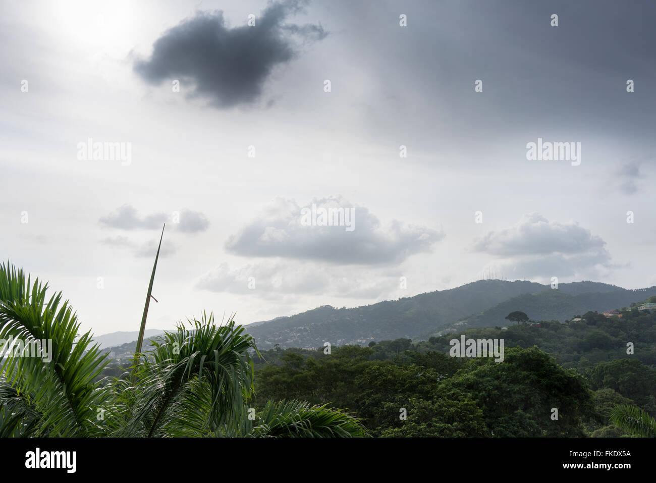 Distant view of city with mountain against cloudy sky, Trinidad, Trinidad And Tobago Stock Photo