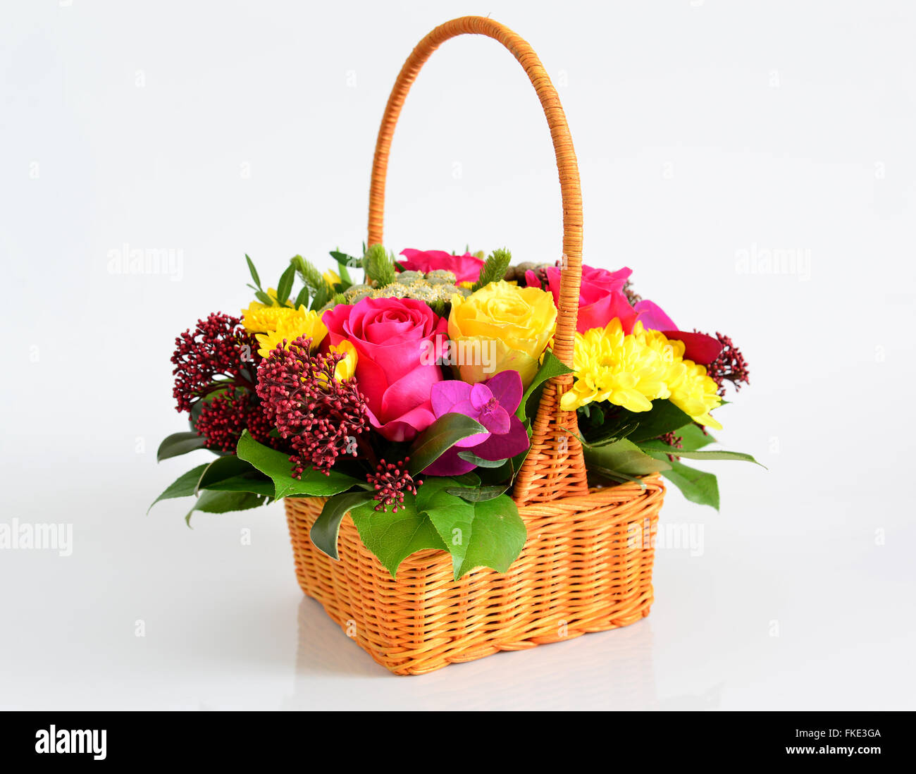 Beautiful flowers in wicker basket on light background Stock Photo - Alamy
