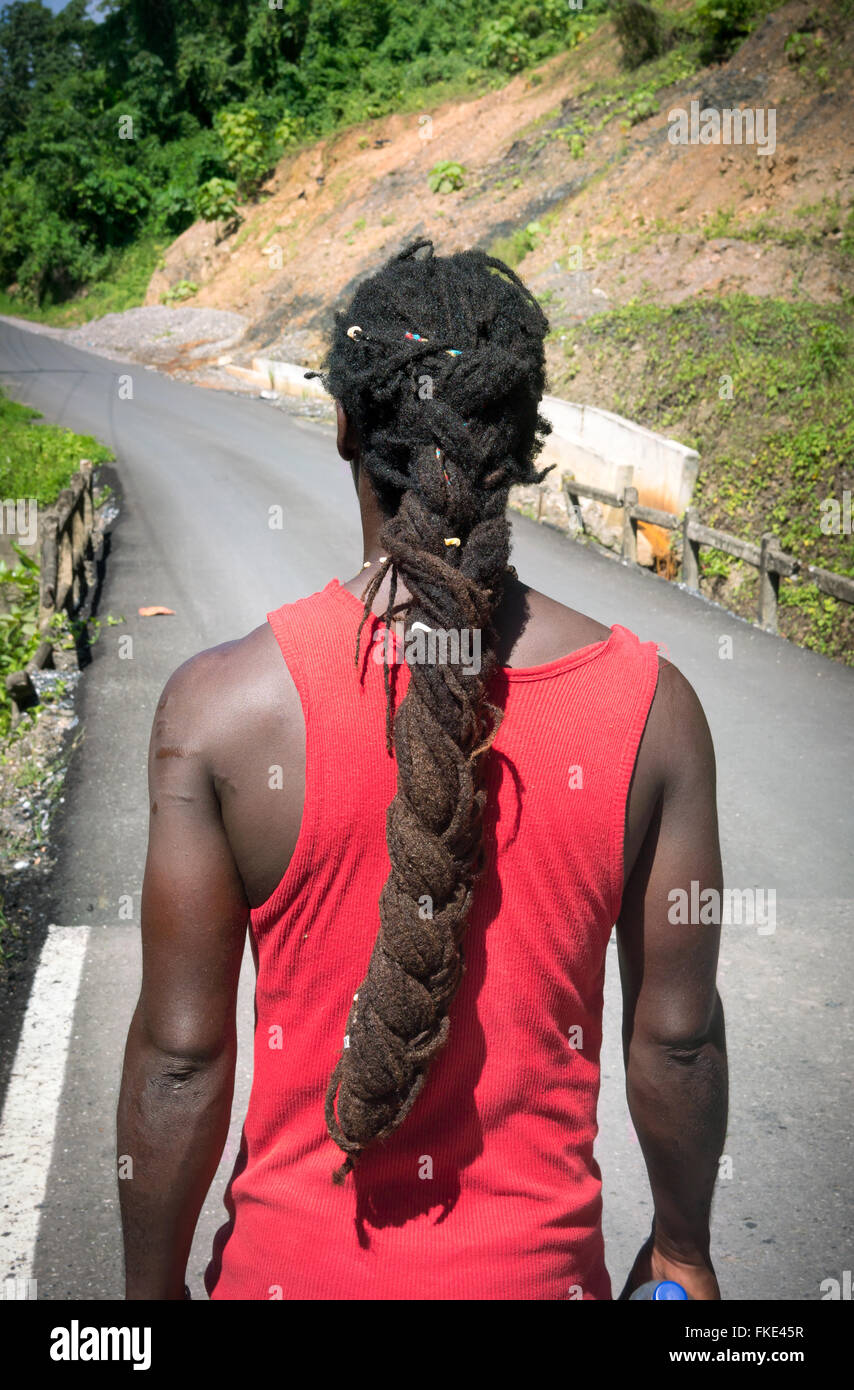 Rear view of man standing on road and looking forward, Trinidad, Trinidad and Tobago Stock Photo