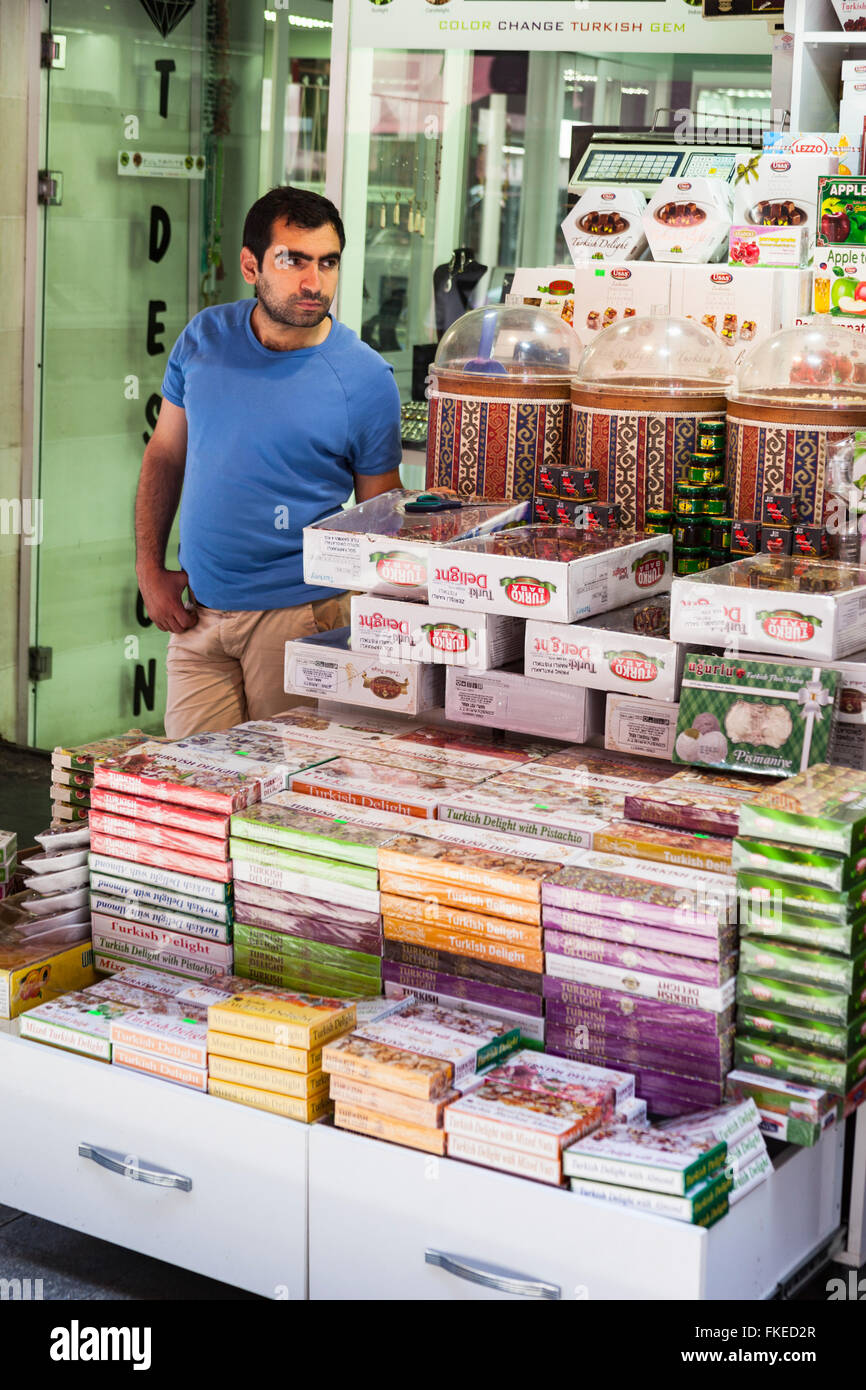 Shopkeeper standing beside Turkish delight confectionery stall, Istanbul, Turkey Stock Photo