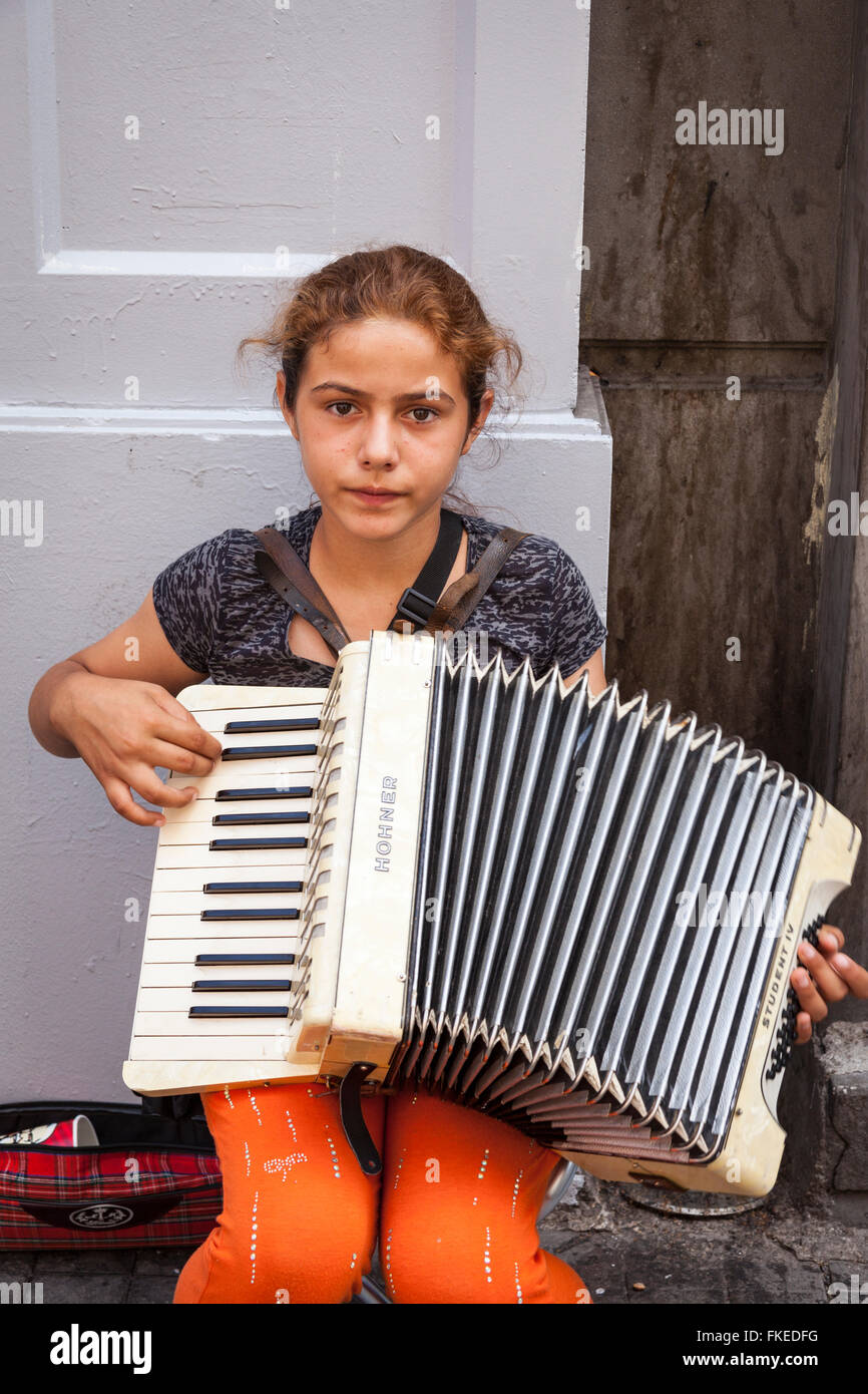 Young girl playing an accordion in a street, Istanbul, Turkey Stock Photo