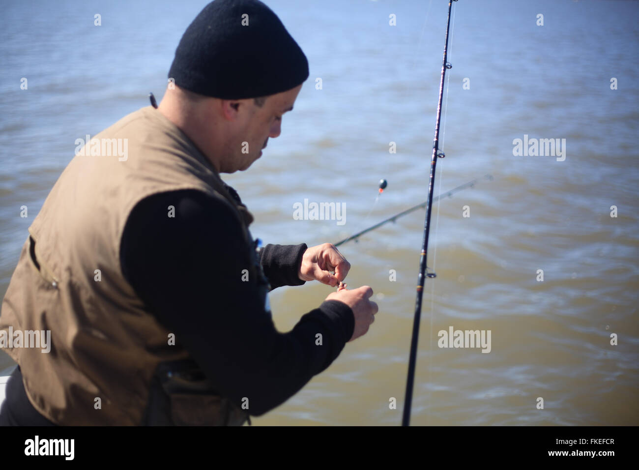 Fisherman baiting hook Stock Photo