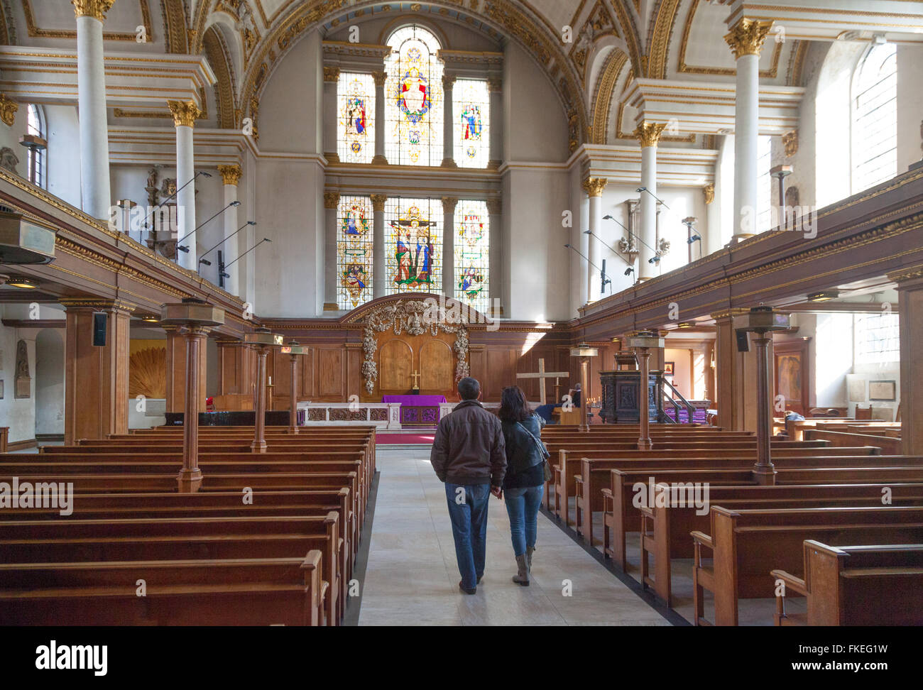 A couple looking at the interior of St James Church, Piccadilly London UK Stock Photo
