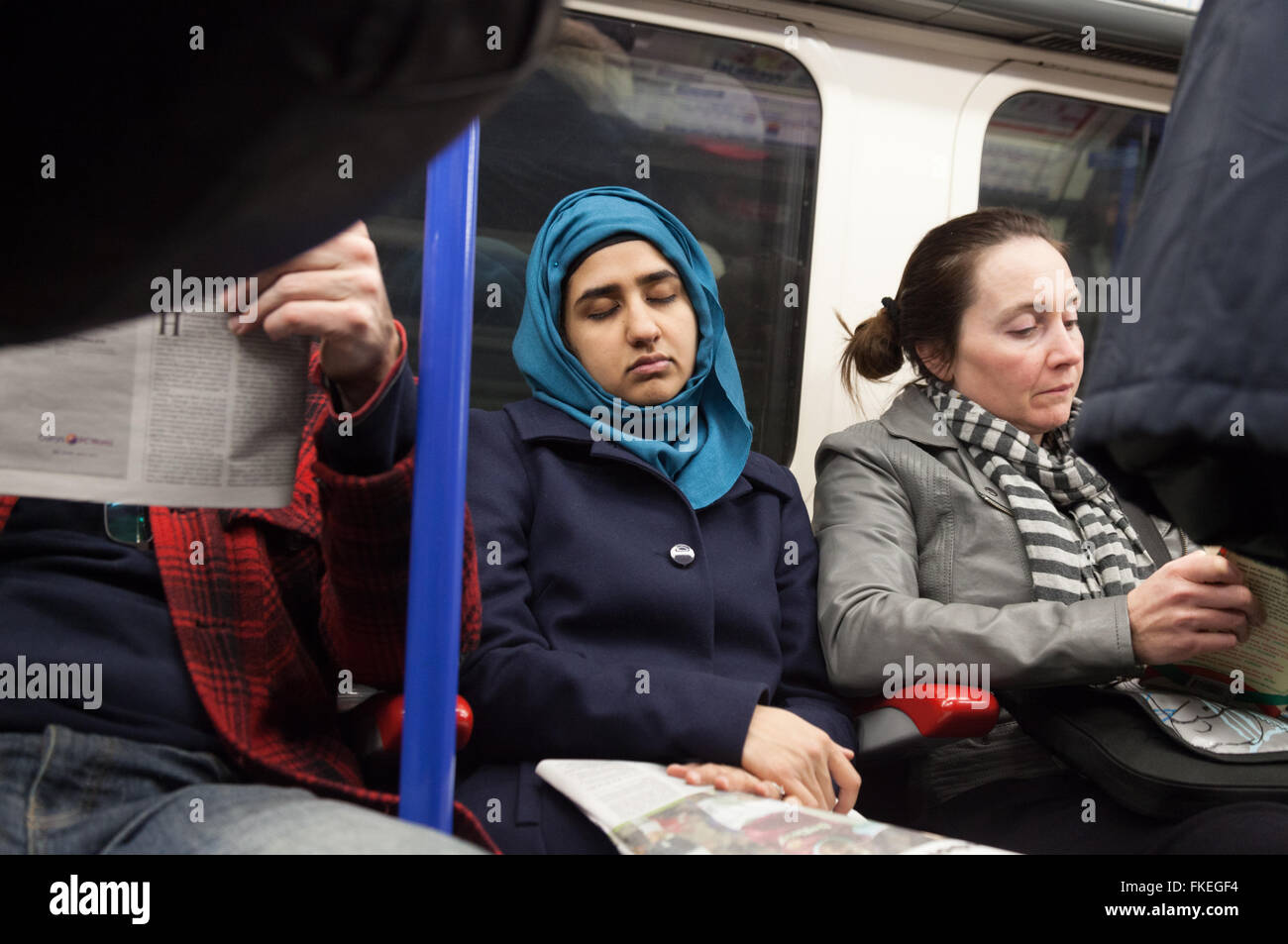 Woman sleeping in a  London underground train carriage, London UK Stock Photo