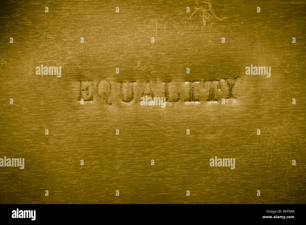 word equality printed on  golden metallic background texture Stock Photo