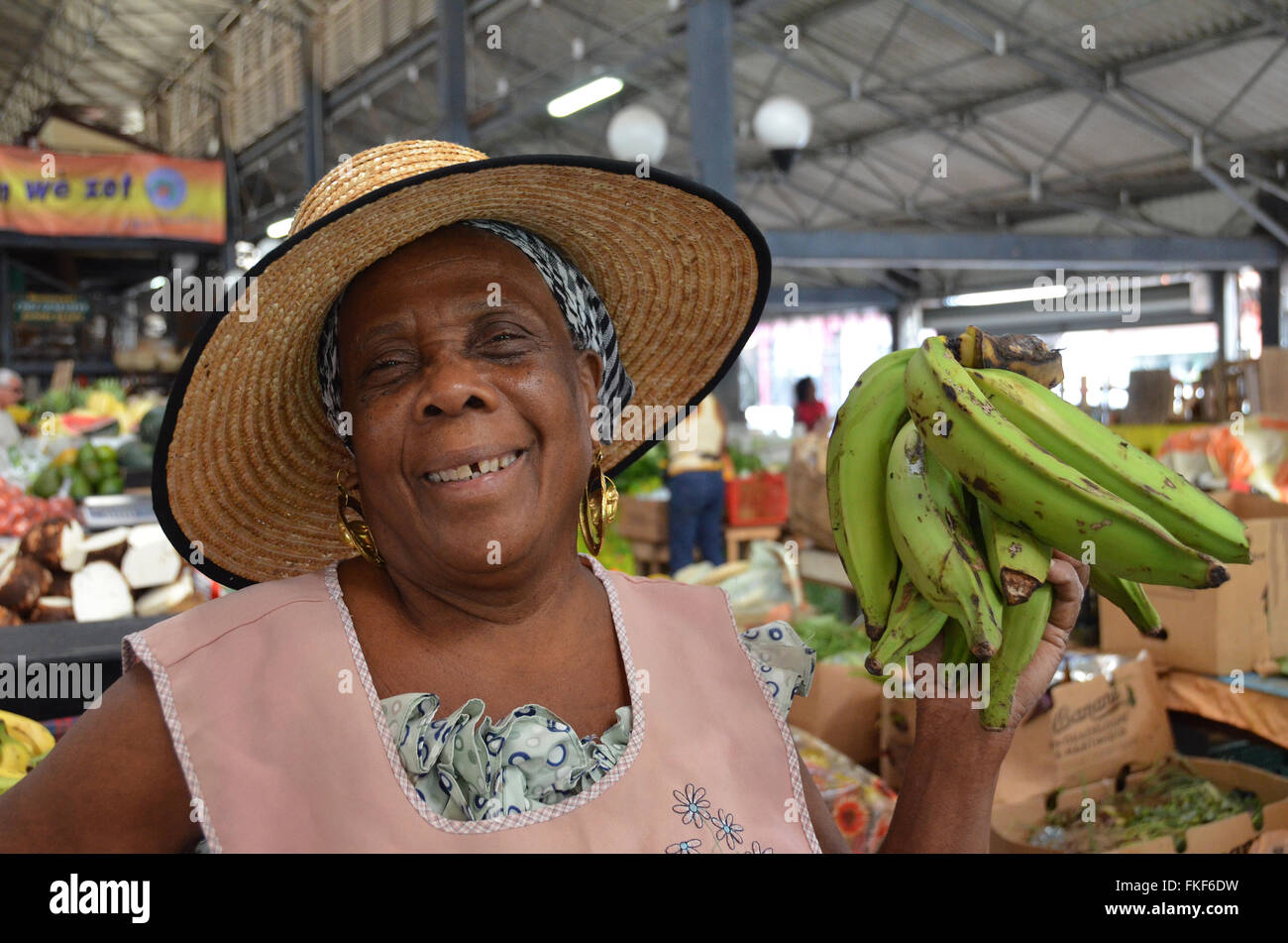 Local market trader, selling Bananas in the covered market  in Fort-de-France, Martinique. Stock Photo