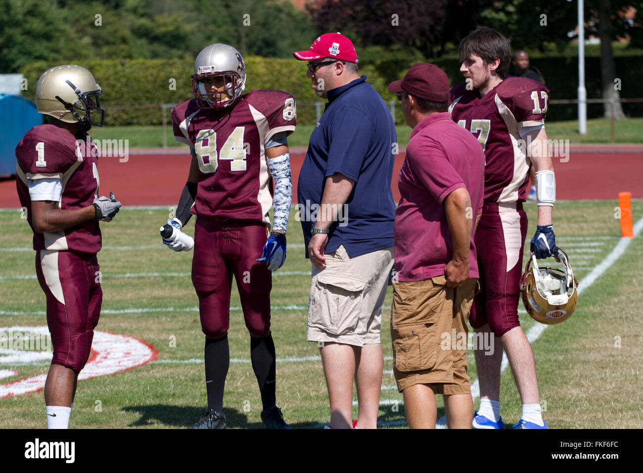 On a hot sunny day coaches and American football players Stock Photo
