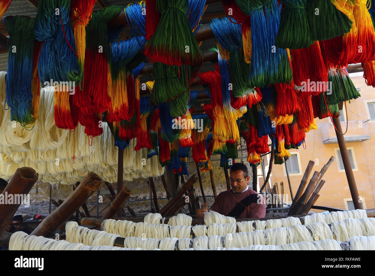 Cairo. 8th Mar, 2016. A worker processes yarn at a dyeing factory at Al