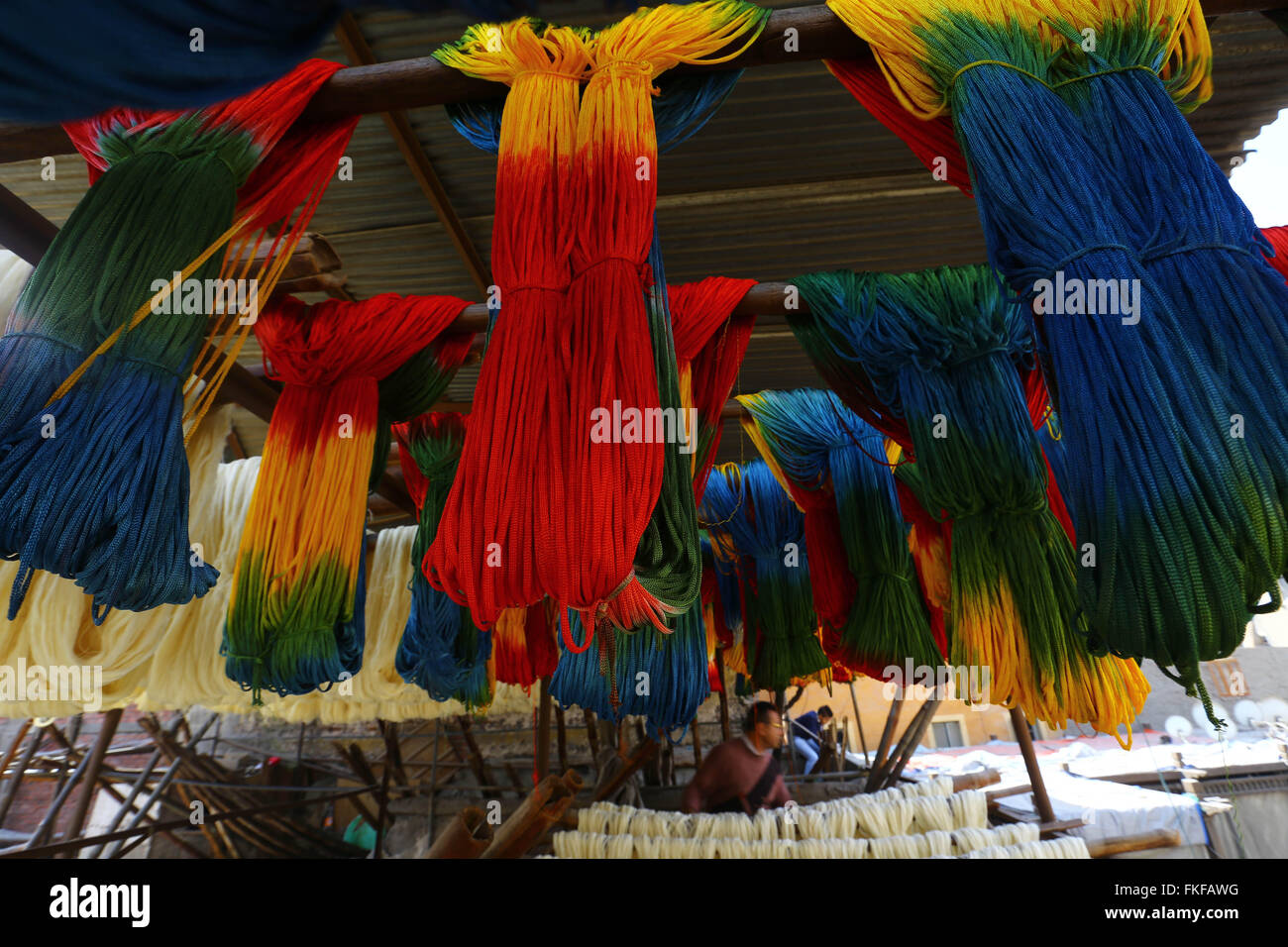 Cairo. 8th Mar, 2016. Workers process yarn at a dyeing factory at Al