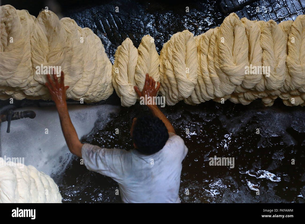 Cairo. 8th Mar, 2016. A worker processes yarn at a dyeing factory at Al