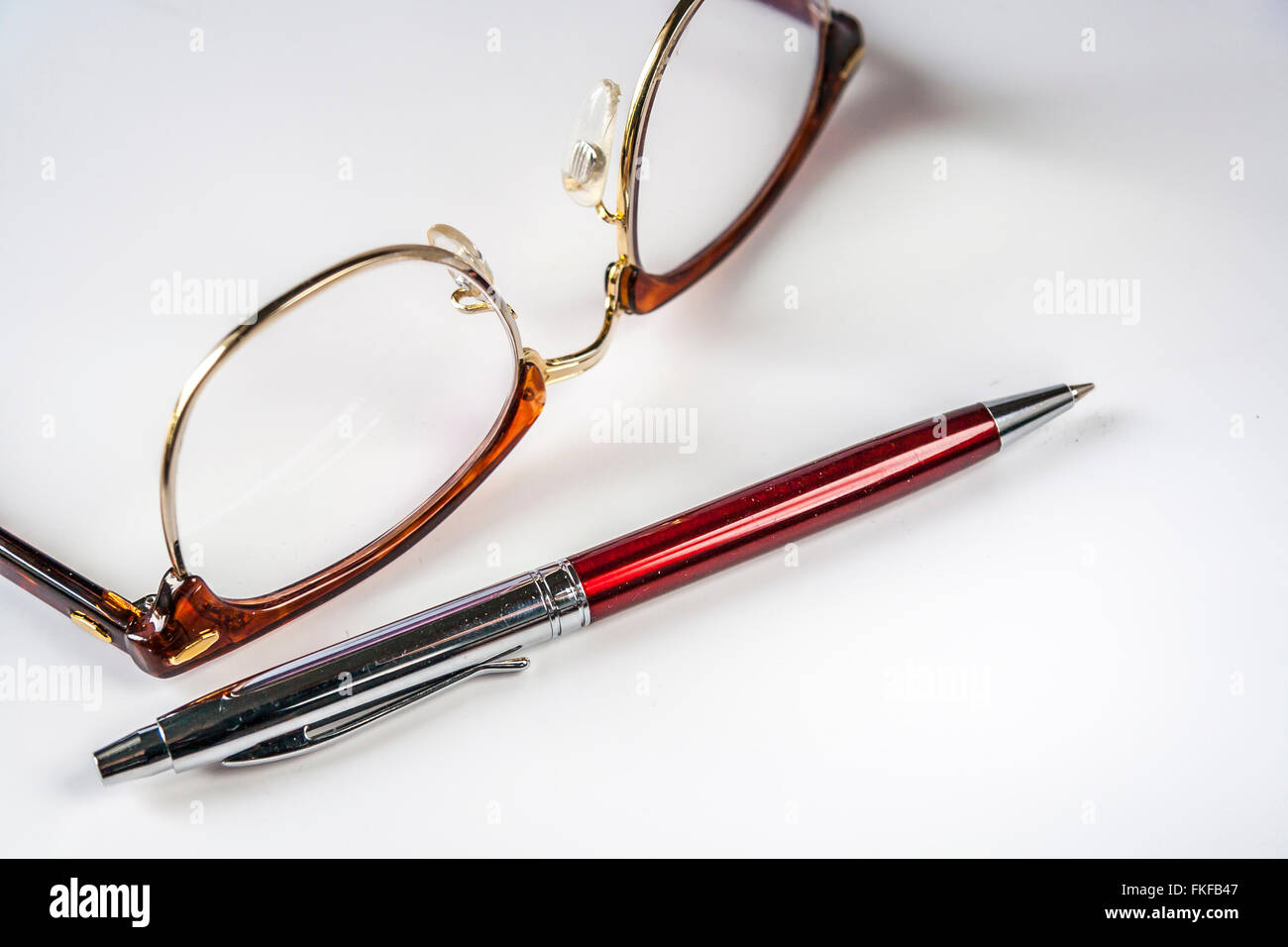 Horn-Rimmed Glasses And Pen Stock Photo