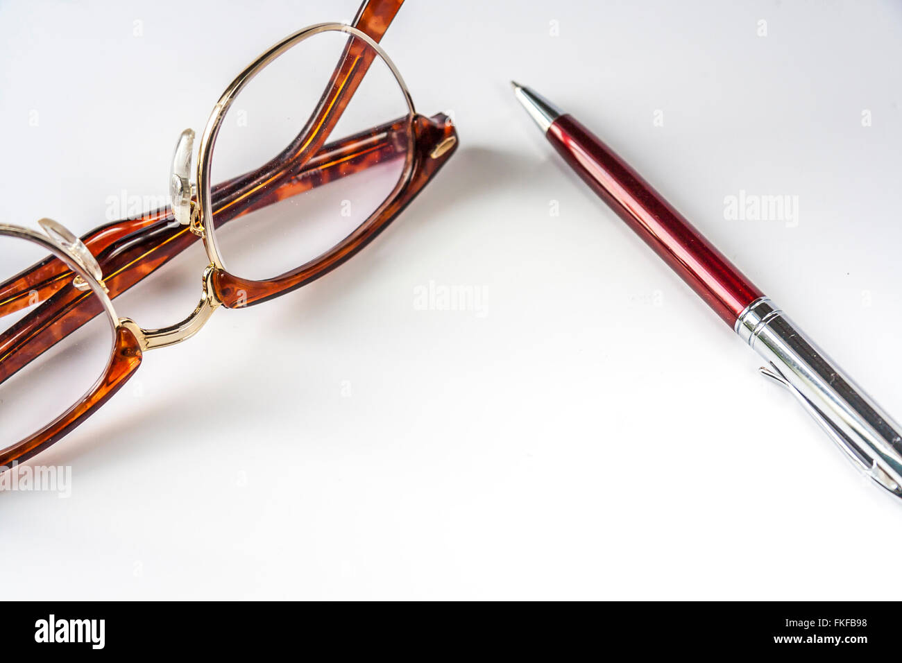 Horn-Rimmed Glasses And Pen Stock Photo