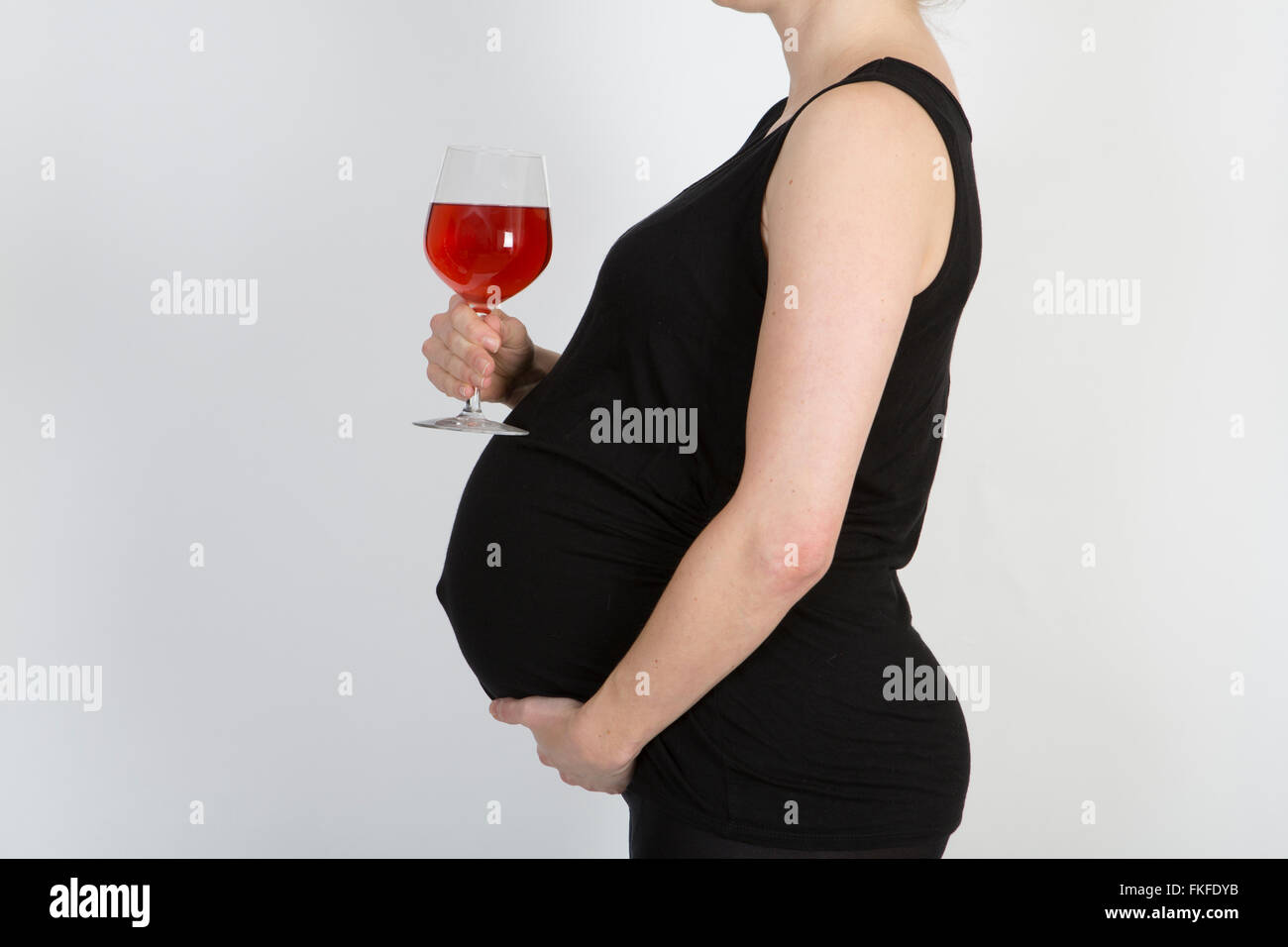 Pregnant lady with alcohol. Stock Photo