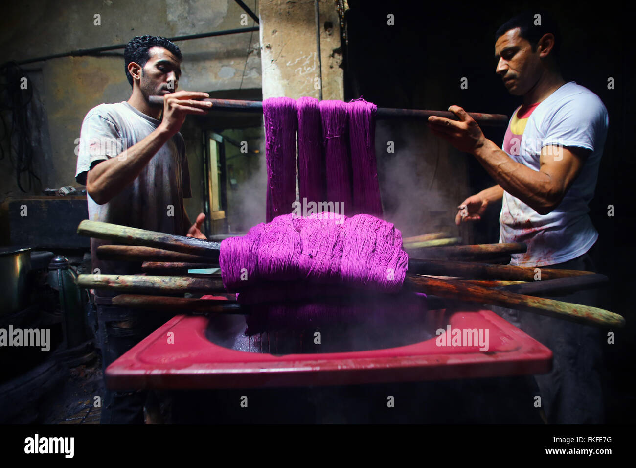 Cairo. 8th Mar, 2016. Workers process yarn at a dyeing factory at Al