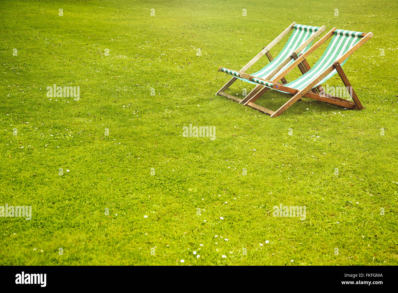 Deck chairs in the park Stock Photo - Alamy