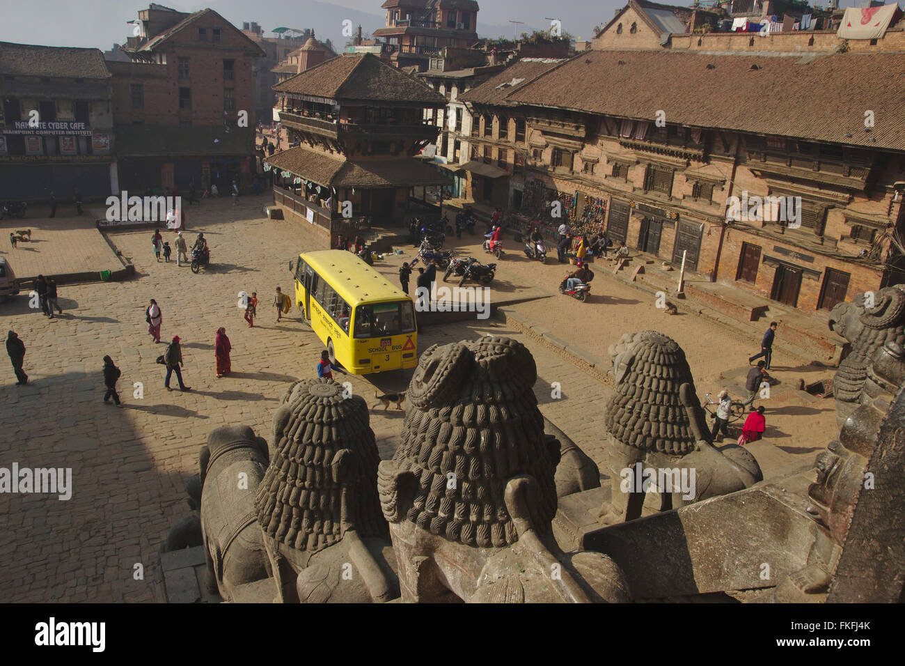Bhaktapur, schoolbus on Taumadhi Pole, view from the stairs of Nyatapola Temple, Nepal Stock Photo