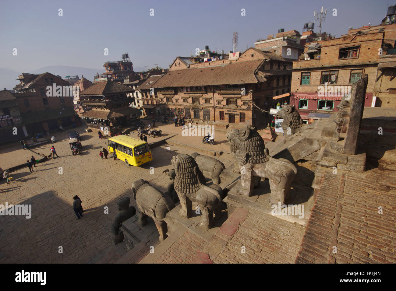 Bhaktapur, schoolbus on Taumadhi Pole, view from the stairs of Nyatapola Temple, Nepal Stock Photo