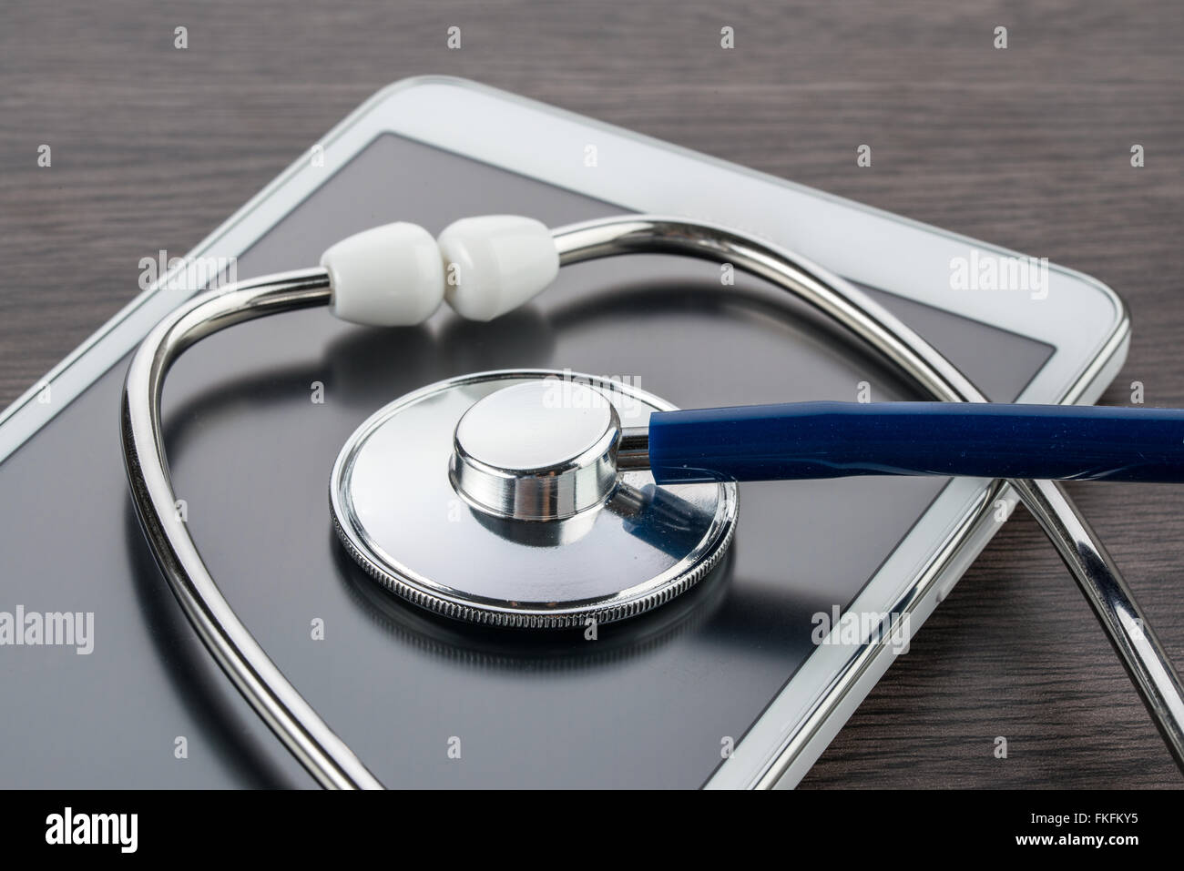 digital tablet and stethoscope on wood desk in Doctor workplace Stock Photo