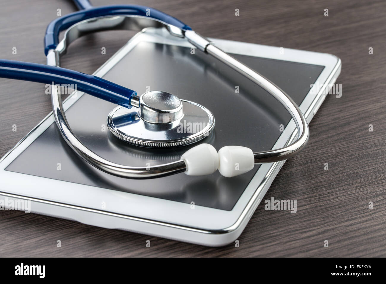 digital tablet and stethoscope on wood desk in Doctor workplace Stock Photo