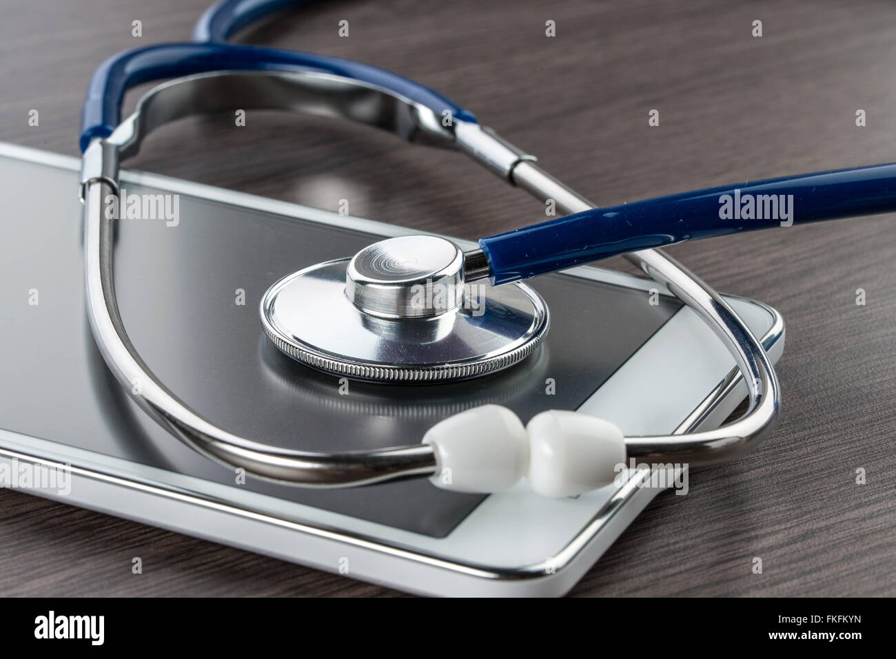 digital tablet and stethoscope on wood desk in Doctor workplace Stock Photo