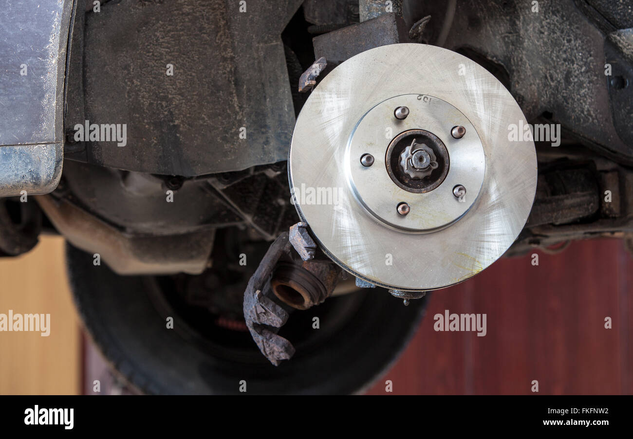 Auto in service. Front disk brake on car in process of damaged tyre