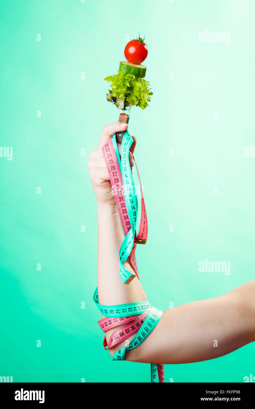 Diet and weight loss concept. Dietician woman hand with vegetarian food