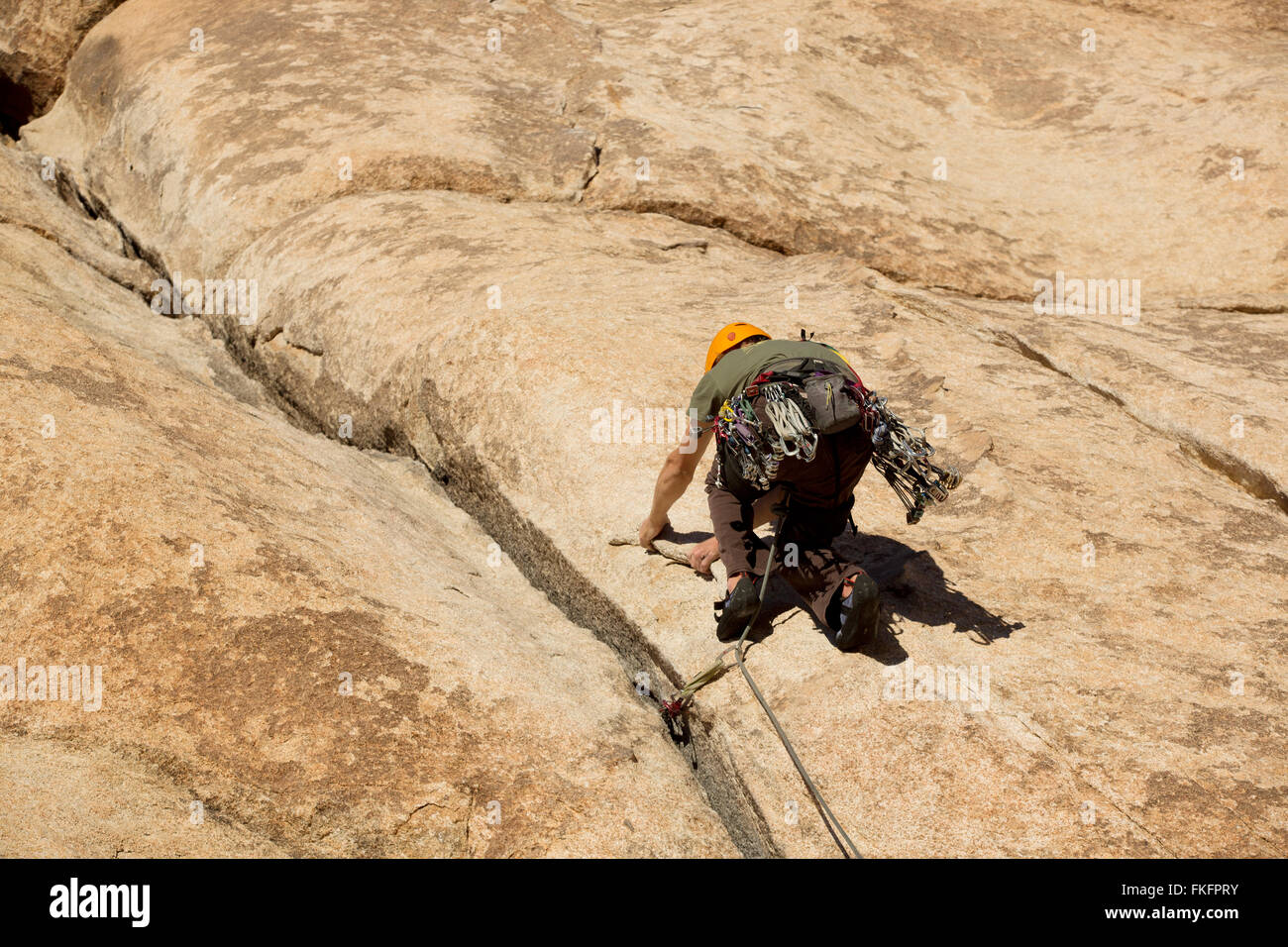 Man rock climbing, Hidden Valley, Joshua Tree National Park, California, USA Stock Photo