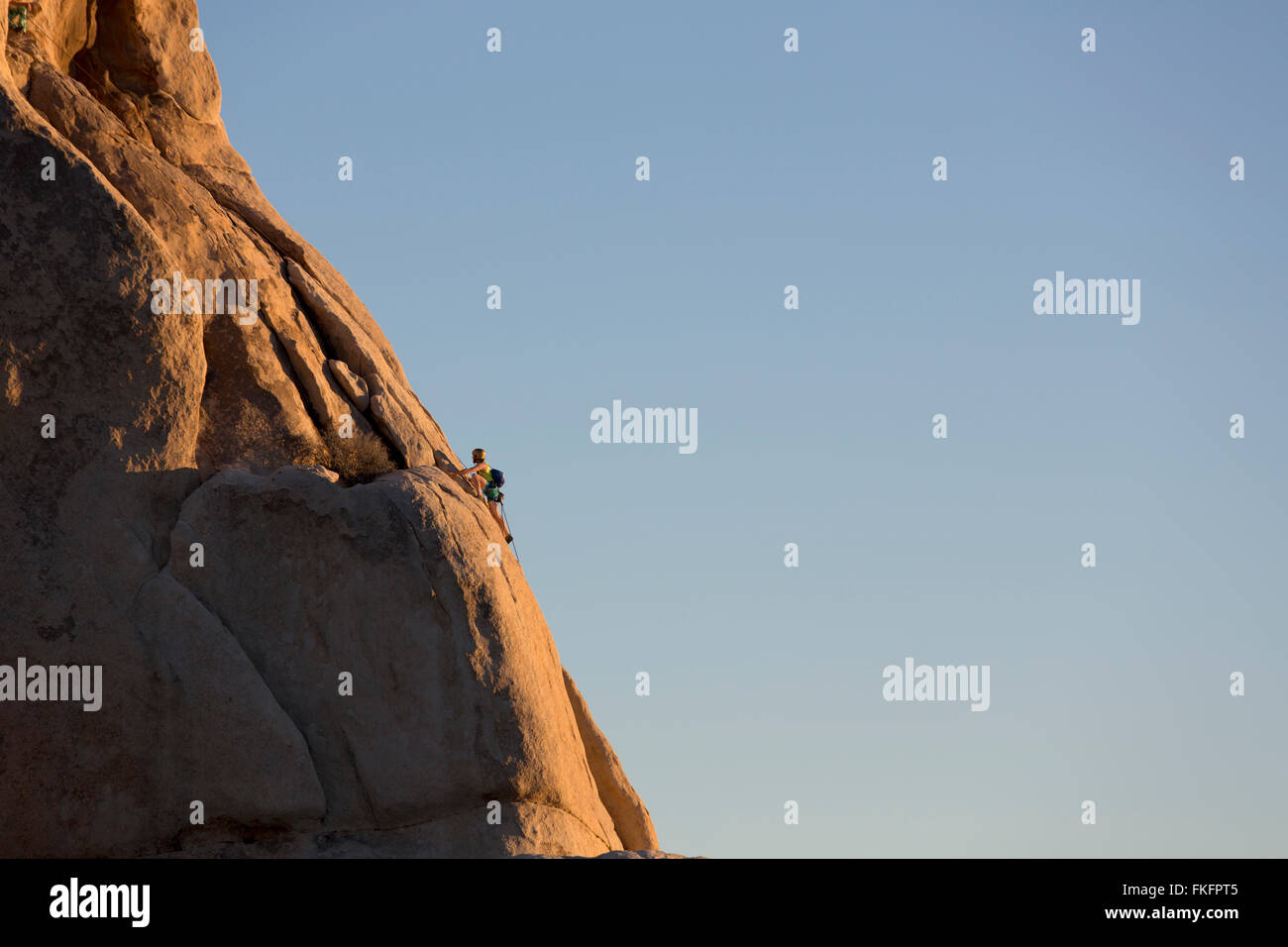Person rock climbing, Hidden Valley, Joshua Tree National Park, California, USA Stock Photo