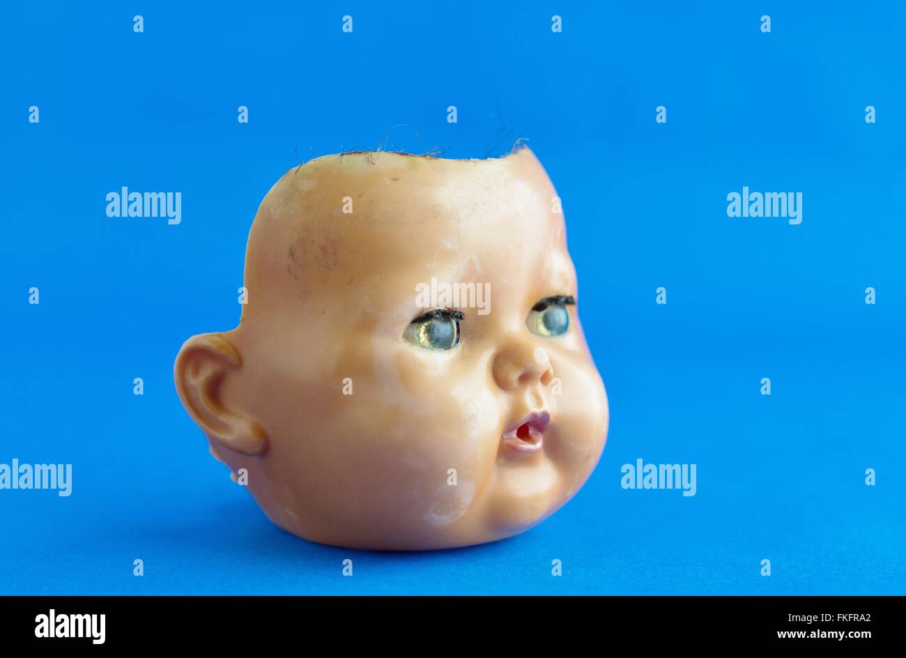 The face of a creepy old doll. Stock Photo